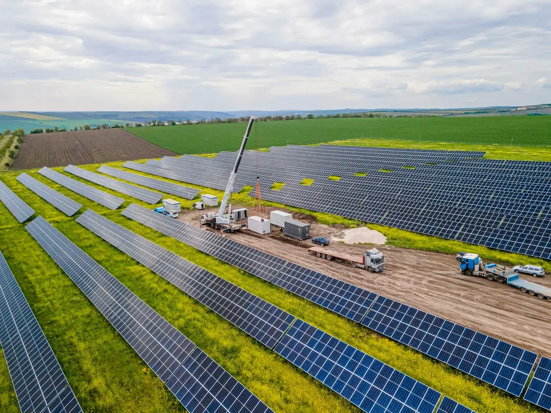 Solar farm construction site with a crane